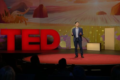 Eric Liu standing on the TED Talks stage.