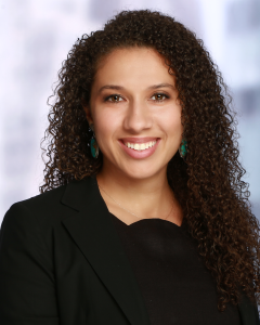 A head shot image of Aria Florant, Co-founder and Managing Director of Liberation Ventures. She has curly hair and is wearing the color black.