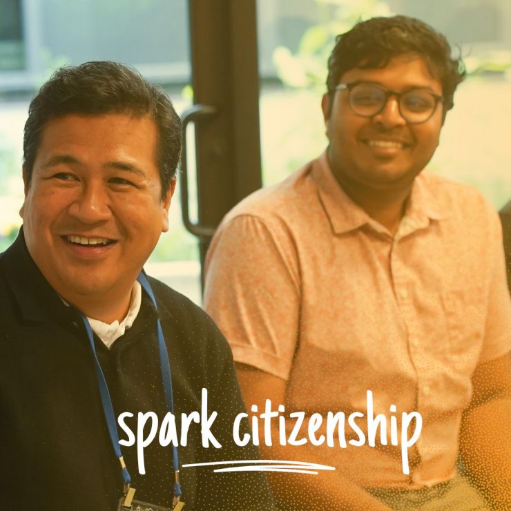 Three people sitting and smiling together, with the text, spark citizenship.
