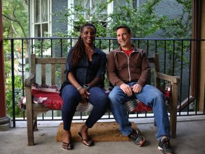 Two people sitting on a bench together.